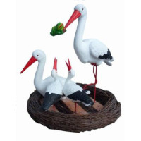 Storkfamilj i bo – dekorativ glasfiberskulptur