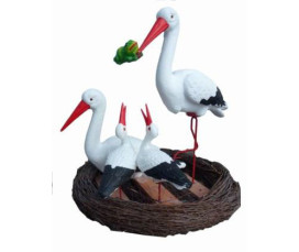 Storkfamilj i bo – dekorativ glasfiberskulptur
